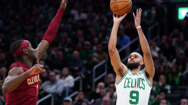 Dec 12, 2023; Boston, Massachusetts, USA; Boston Celtics guard Derrick White (9) shoots for three points against Cleveland Cavaliers guard Caris LeVert (3) in the second half at TD Garden.